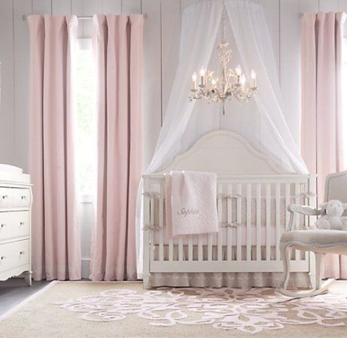 a vintage girlish nursery with vintage elegant furniture, a canopy and a crystal chandelier plus pink textiles