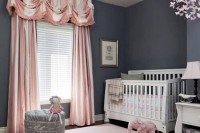 a refined grey and blush nursery with graphite walls, white furniture and pink and blush textiles