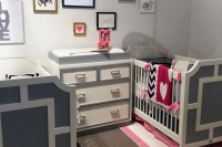 a bright modern nursery in grey and various neutrals, with geometric patterns, colorful linens and a gallery wall