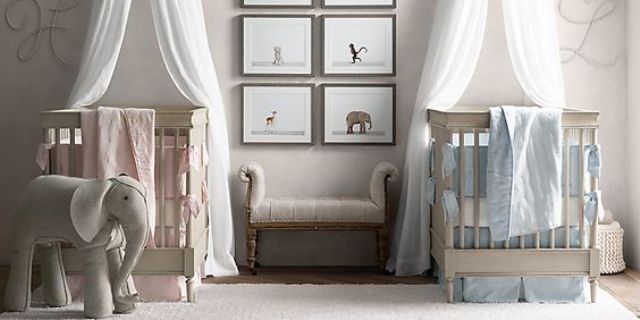 an all-neutral shared nursery with neutral furniture, artworks and toys and blue and pink linens to accent each baby's space