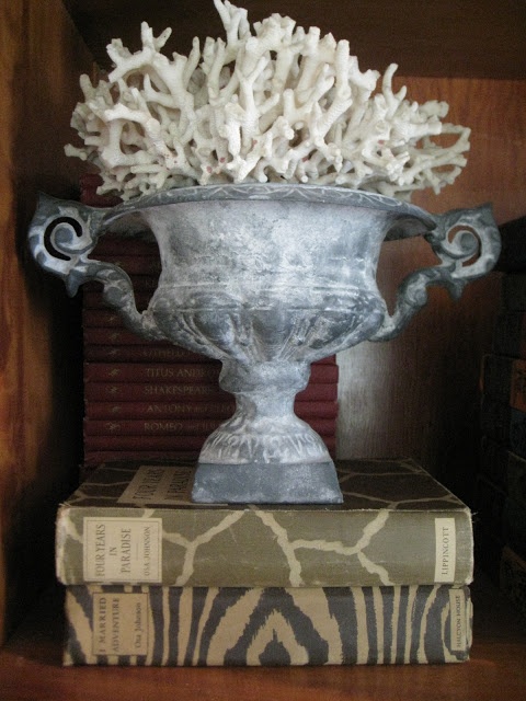 A vintage stone urn with corals is a beautiful vintage inspired decoration for both indoors and outdoors