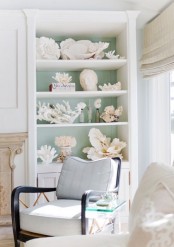 an outdoor storage unit filled with seashells and corals is a gorgeous solution that will scream seaside and seas