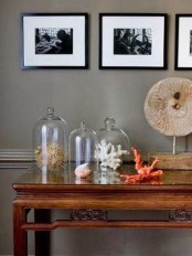 seaside home decor made of corals placed in cloches is a lovely idea for a seaside or coastal wedding