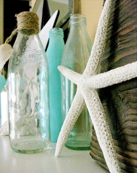 sheer and blue bottles with rope and a starfish on the mantel to make it feel beach-like