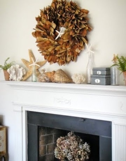 Seashells, corals, starfish, some blooms and a dried leaf wreath over the mantel to make it look beachy yet fall infused