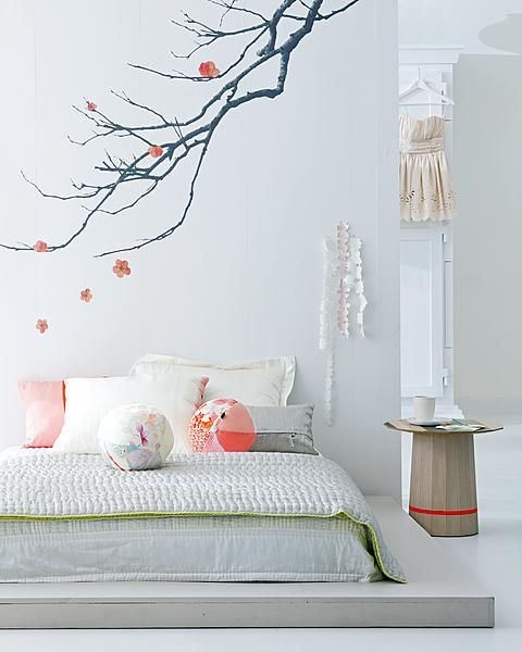 use wall decals on the wall over the bed to make your bedroom feel more like spring