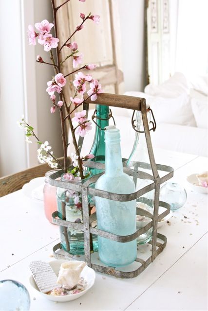 a holder with bottles and cherry blossoms is a cool idea with a vintage touch to the space
