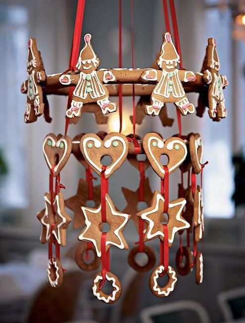 a creative Scandinavian chandelier composed of glazed gingerbread cookies and red ribbon is a very cute and lovely idea to rock