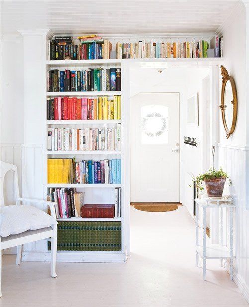 a doorway with open bookshelves is a lovely idea to store books and add a colorful accent to the space