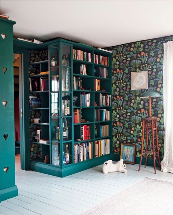 a built-in open shelving unit on the left of a doorway is a cool idea to store the books and make use of an awkward nook in the room