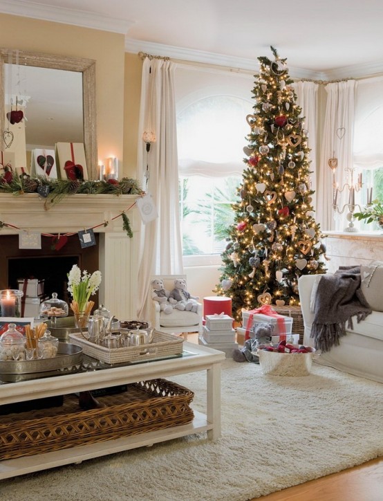 a fir garland with pinecones, a Christmas tree with lights, red and white ornaments create a holiday ambience in this living room