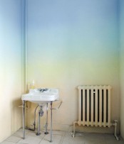 a usual bathroom turned super boldwith ombre blue to green, yellow and orange walls that just blow your mind