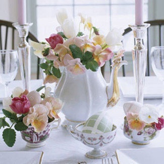 a vintage tea pot with white, pink and burgundy blooms and egg cupes with the same blooms