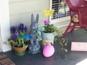 a cute Easter decoration with potted flowers, an oversized egg and a vintage-inspired bunny