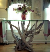 a pretty table of a driftwood base and a glass tabletop is a lovely idea for many spaces, in many styles and you can DIY it