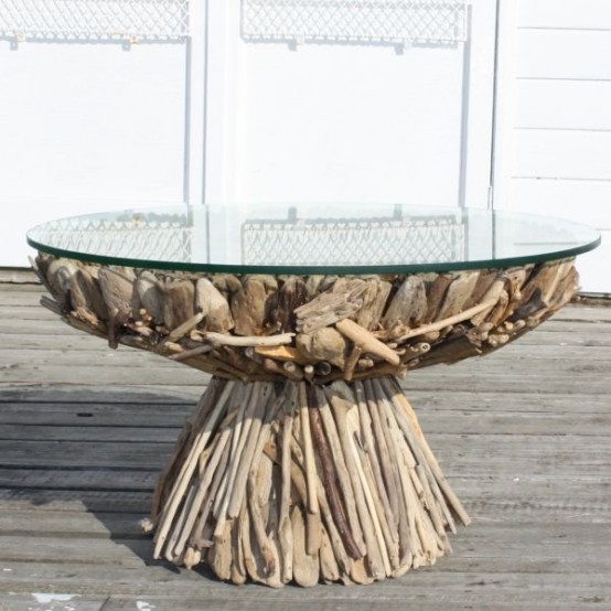 a unique dining table, the base of which is fully composed of driftwood and with a round glass tabletop is a fantastic solution and an eco-friendly decoration