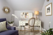 a small yet elegant home office with grey walls, a purple sofa, a refined white desk and a chair plus potted orchids