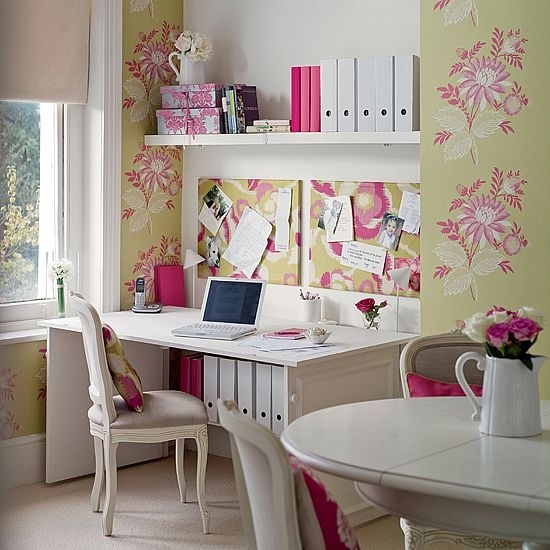 a pretty feminine home office with floral wallpaper, a comfy desk and open shelves, a white table and chic chairs
