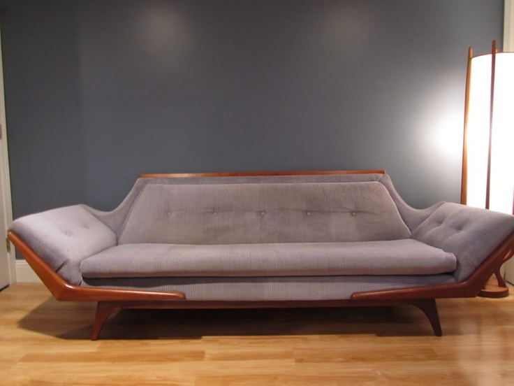 A refined grey lavender sofa with a rich stained frame is a catchy idea for a mid century modern space