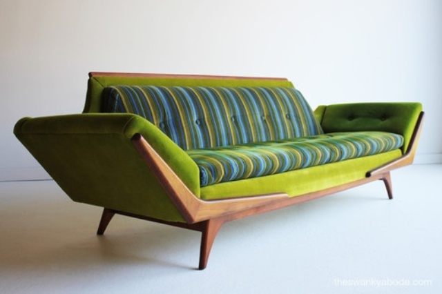A bright green and blue mid century modern sofa with a stained frame is a catchy and colorful idea for a modern space