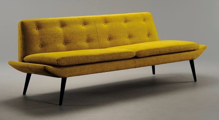 A mustard mid century modern sofa with a visible base is a catchy idea to style your space as a boho or mid century modern one