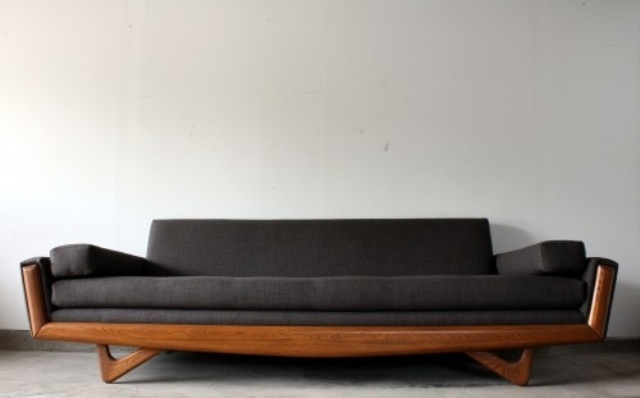 A black mid century modern sofa with a stained frame is a stylish and practical solution for many spaces