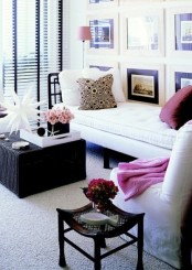 a bold small living room with contemporary furniture, a large gallery wall, printed pillows and a glazed wall with shades