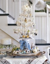 a white tabletop mini Christmas tree with beads, pearls and metallic ornaments is a cool vintage-inspired idea