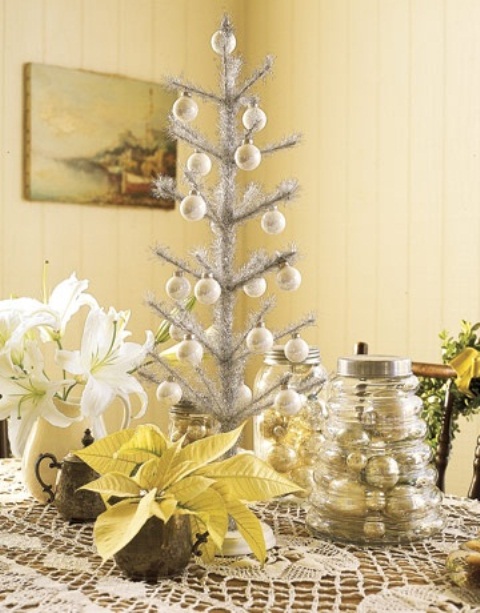 a silver tabletop Christmas tree with mother of pearl ornaments is a shiny and bright idea for holiday decor