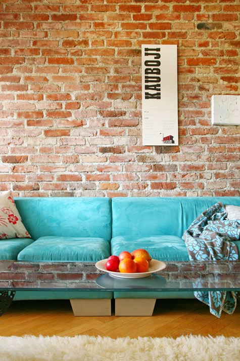Contemporary sofas looks great against exposed brick walls in living rooms.