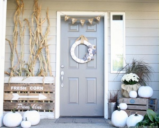 white pumpkins paired with white blooms and husks will make your front porch look rustic and fall-like