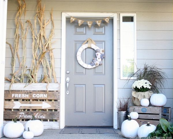 White pumpkins paired with white blooms and husks will make your front porch look rustic and fall like