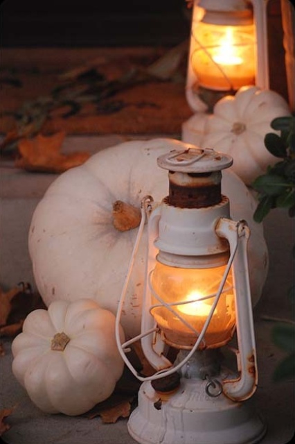 decorate your front porch with white pumpkins and white lanterns to make it look very fall-like and very cozy