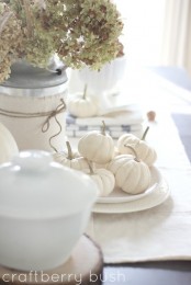 place white pumpkins into white plates to make your tablescape feel refined, rustic and fall-like