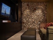 a wood slice accent wall makes the living room rustic and cozy and hides a non-working fireplace at the same time