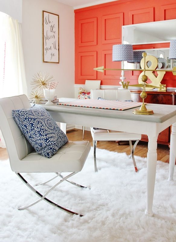 A hot red wall done with empty picture frames add interest, color and texture to the home office