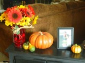 a bright fall flower arrangement with colorful fall pumpkins will be nice for styling your coffee table