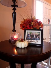 a white pumpkin and a bright fall floral arrangement with leaves for natural and cool fall decor
