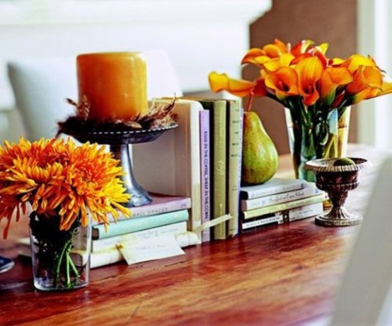 a bright orange candle and bright orange fall floral arrangements can be used anywhere for fall home decor