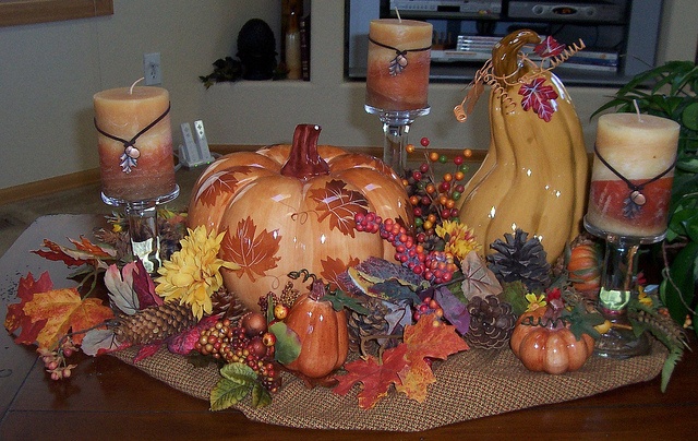 Burlap, fake fall leaves, pumpkins,pinecones and berries plus fall colored candles on each side