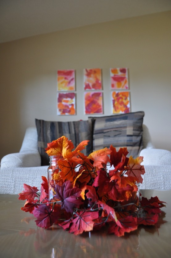 an arrangement of super bright faux fall leaves is all you need to bright a strong fall feel to the space