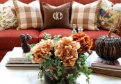a bright fall floral attangement, a squirrel figurine and a woven pumpkin for cozy fall table decor