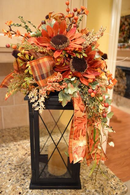 A large enough lantern could become a great stand for a fall blooms bouquet.