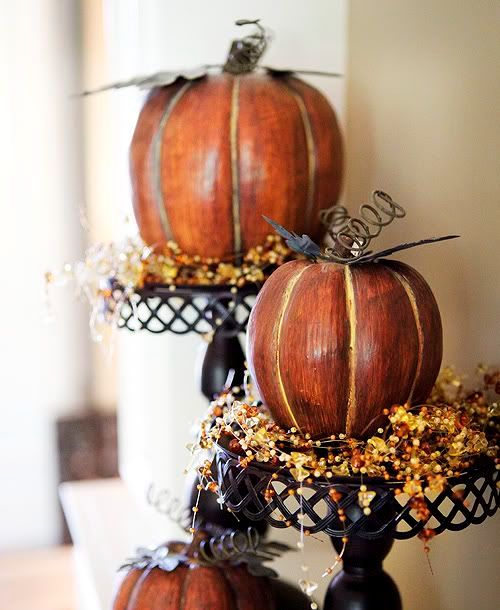 metal stands with faux pumpkins and beads that imitate berries are nice vintage rustic decorations to rock