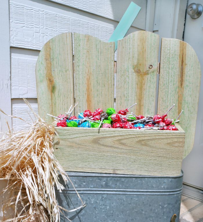 A neutral pumpkin shaped stand with candies is a gorgeous solution for indoors and outdoors