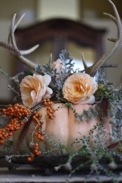 a blush pumpkin with greenery, berries, faux blush blooms and antlers is a chic fall centerpiece for many occasions