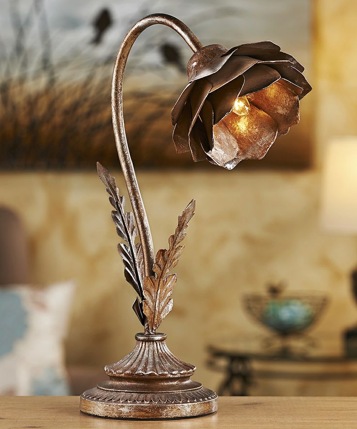 A metal flower shaped table lamp looks industrial and vintage, with a creative and really unusual look