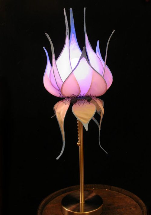 A table lamp with a pink flower shaped lampshade is a creative and bold touch to your interior