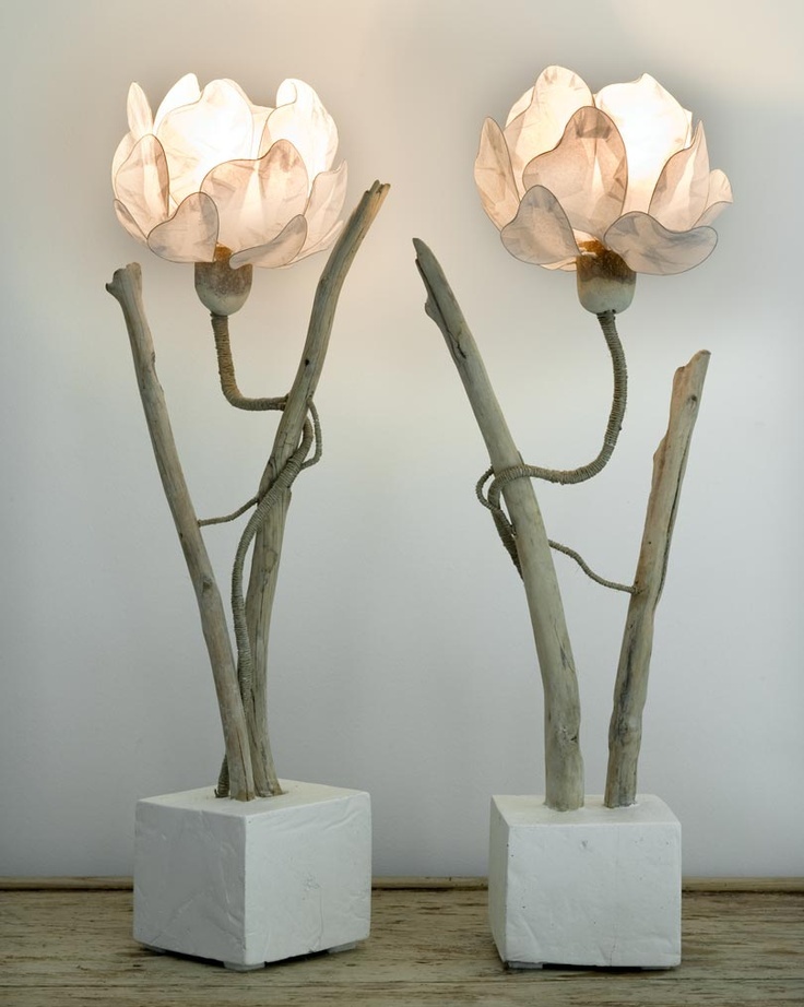 Quirky floor lamps with concrete bases, wooden branches and flower shaped pink lampshades are whimsical lights for your space