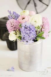 a tin can with pastel and white spring blooms is a beautiful and cool rustic arrangement for your spring-infused space